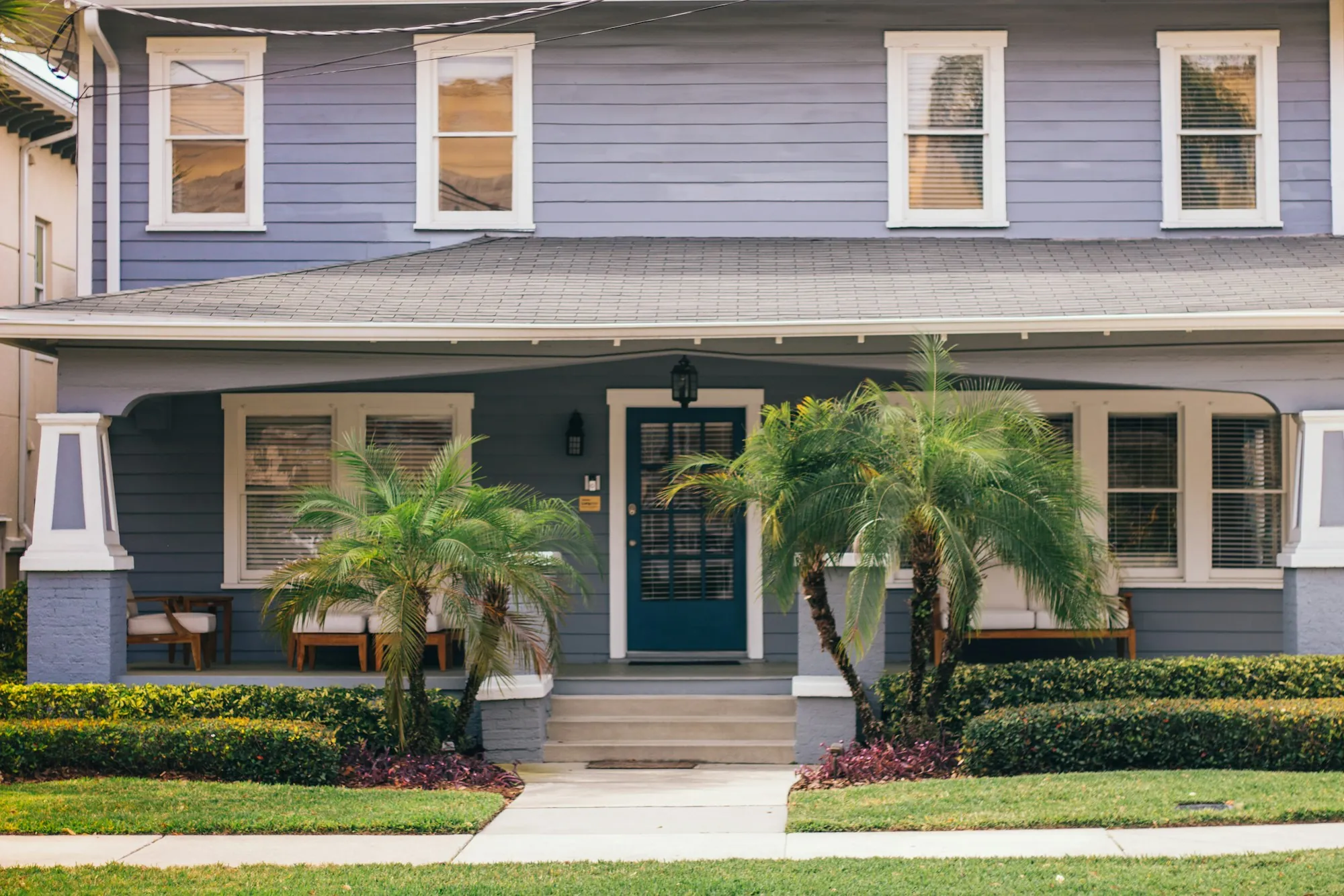 Not Sure Which Service You Need? Blue house with palm trees in front