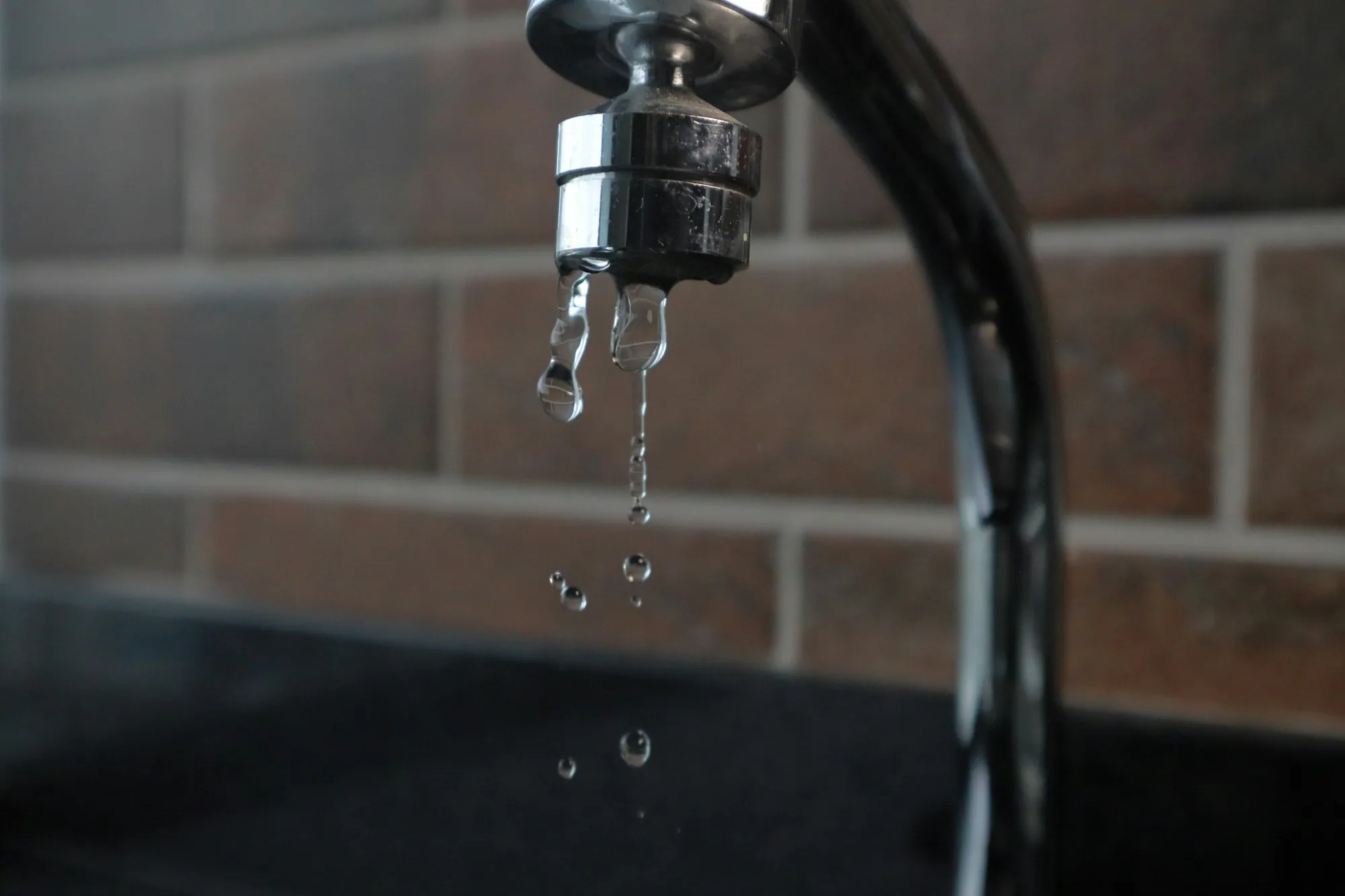 Carbon Filtration Systems in Fountain Valley Faucet with water running from its spout