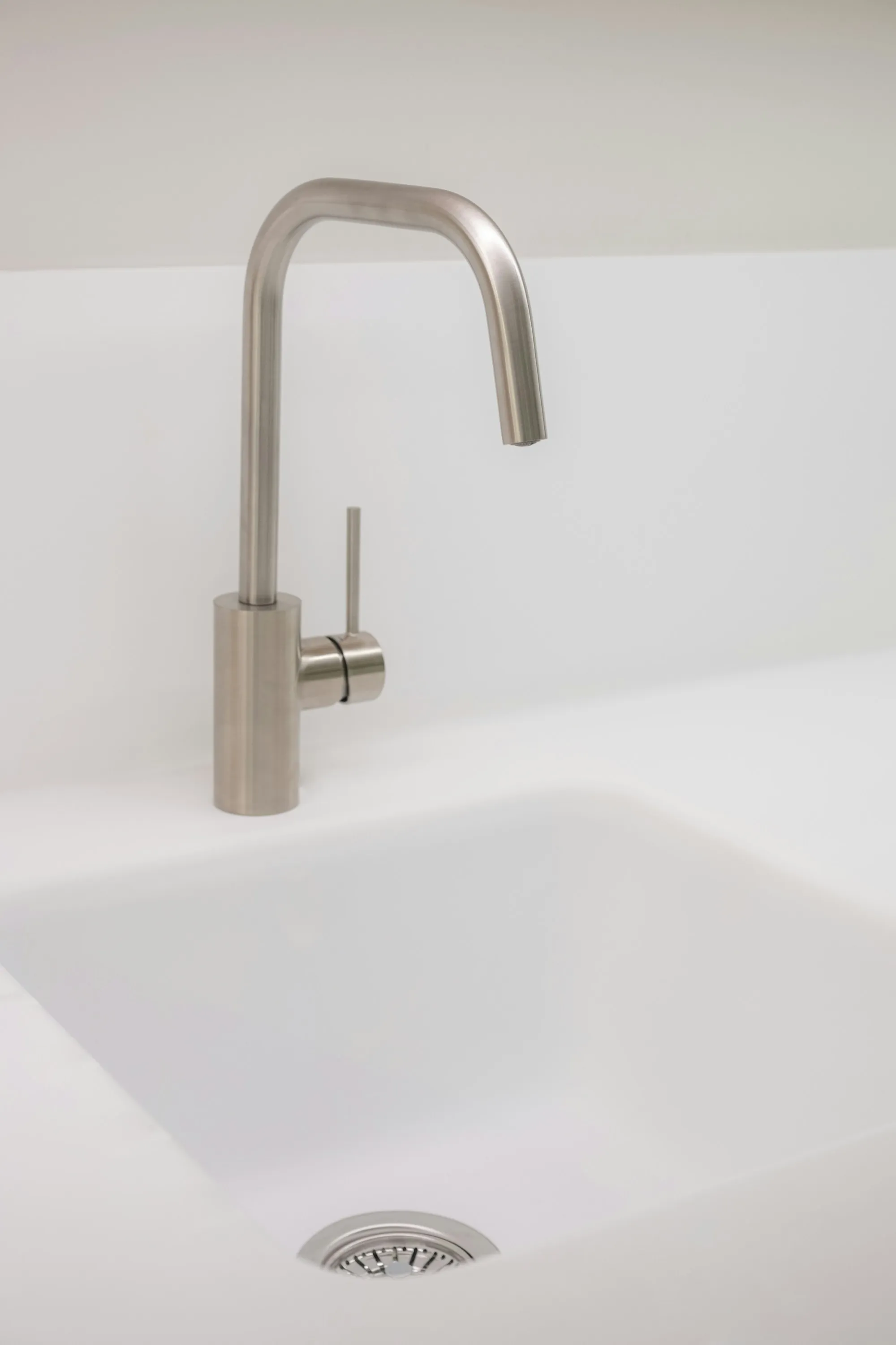 Water Filtration in Fountain Valley, CA, Done by People Who Know Your Water Stainless steel faucet over a white ceramic kitchen sink
