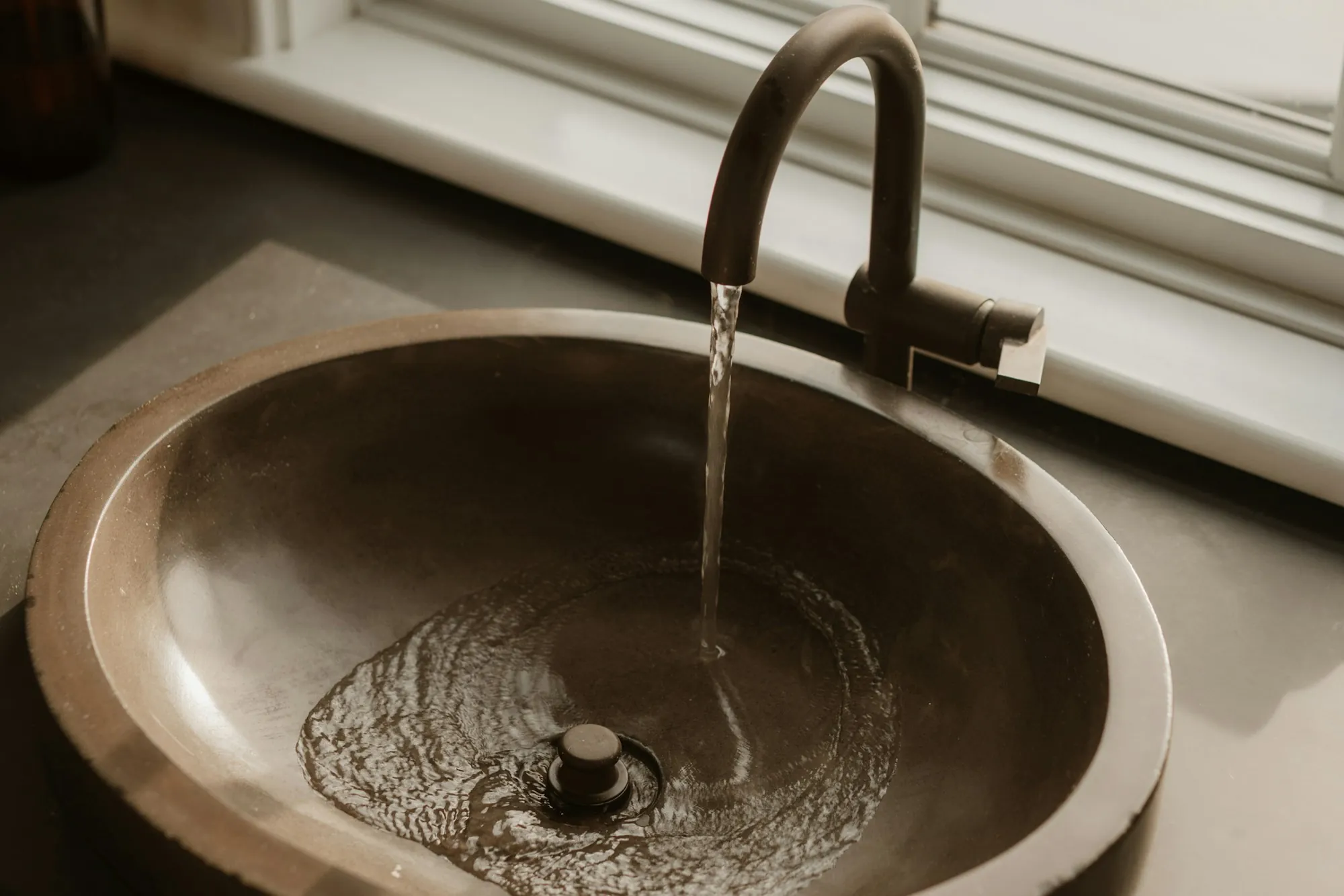 Water Softener Installation in Fountain Valley Water flowing into a bronze sink